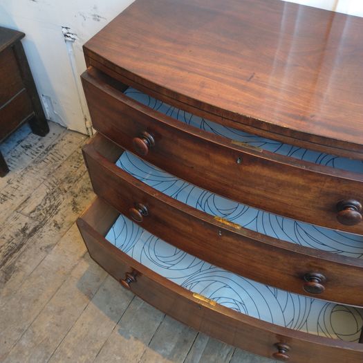 Early Regency bow fronted chest of drawers