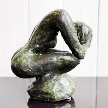 A Bronze Sculpture of a Crouching Woman