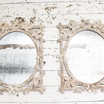 A Pair of Antique Italian Delicately Carved Faux Bois Mirrors with Original Oval Plates