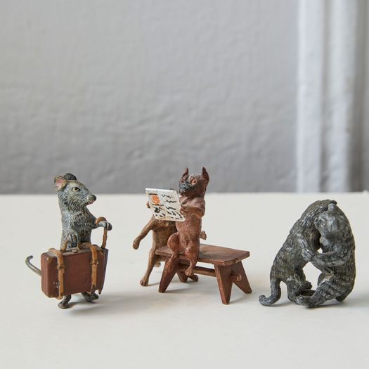 A set of three cold painted metal cast models of pugs, mouse and cats