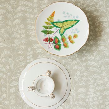 A pair of 19th century porcelain comports with a decorative leaf pattern on a gold three- footed stand.
