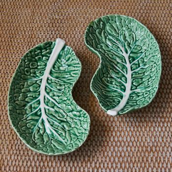 A pair of vintage crescent-shaped cabbage leaf dishes