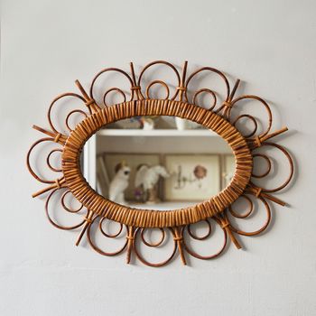 A decorative French mid-century rattan mirror