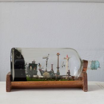 A collection of six vintage 'ships in bottles', each modelled with interior scenes or classic ships made 1950s-1970s
