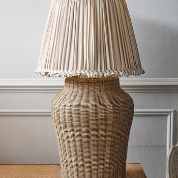 A very large wicker table lamp with a Pooky rust ticking lampshade