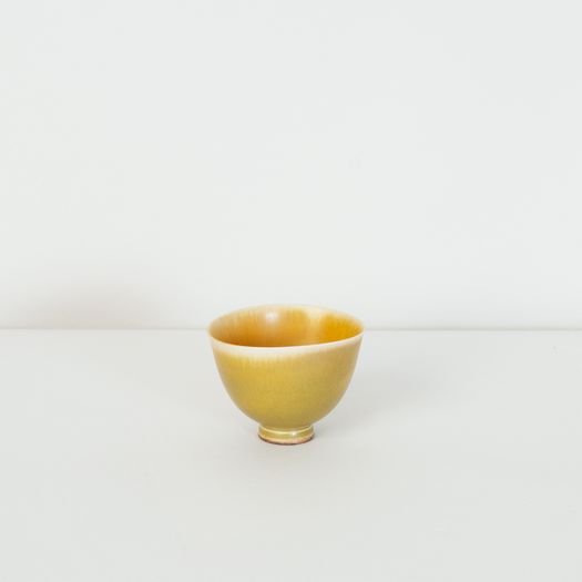 Miniature yellow bowl on foot thrown by Berndt Friberg