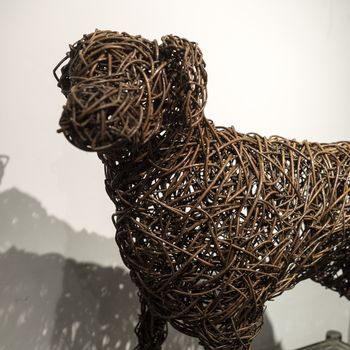 A life sized willow dog sculpture